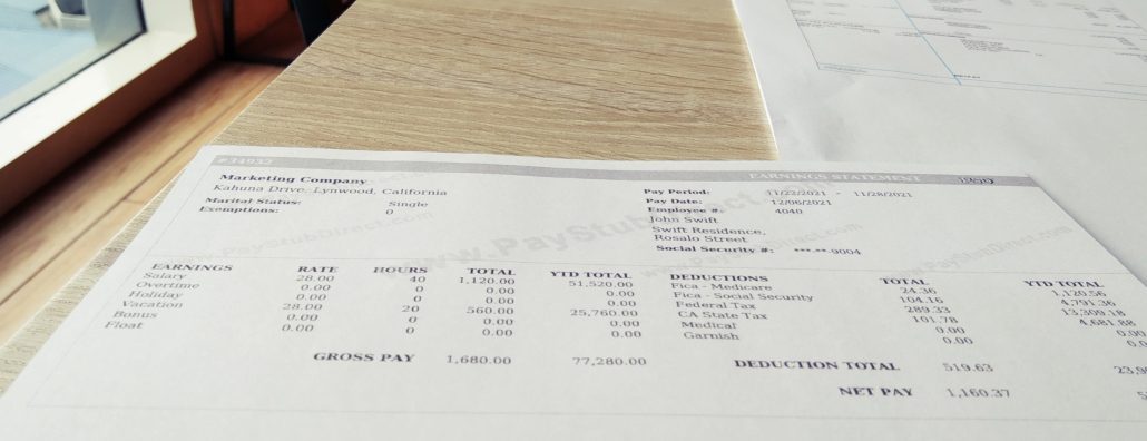 sample pay stub on a desk